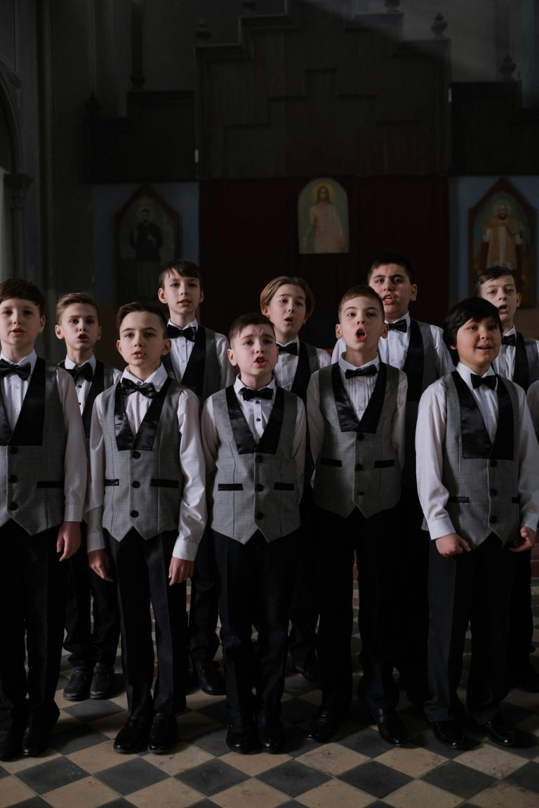 A boys choir in formal attire performs in a church setting, capturing the essence of music and religion.